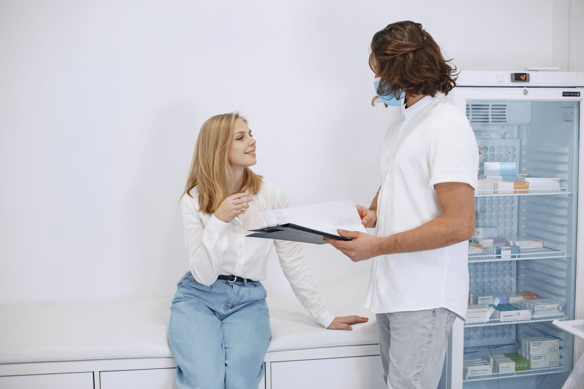 Clinician talking with a patient in an examination room
