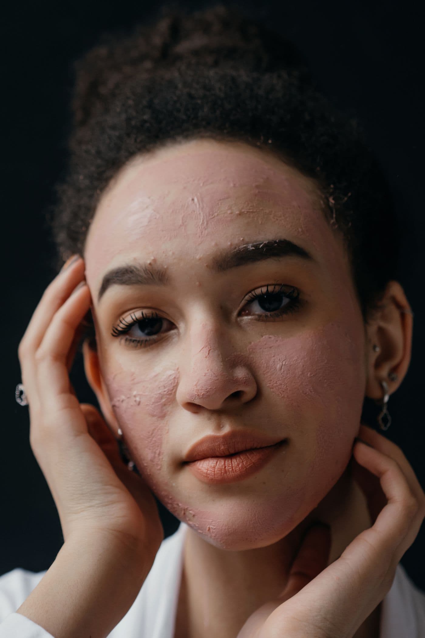 Portrait of a woman with natural curls and glowing skin