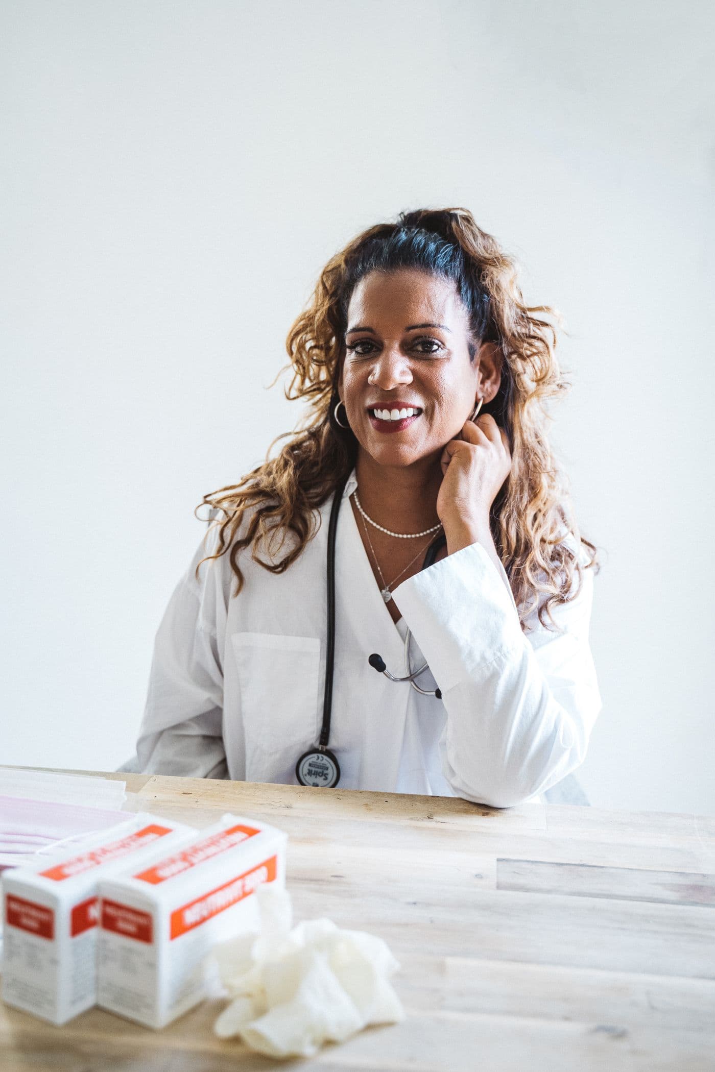Amara Brooks smiling in a white lab coat