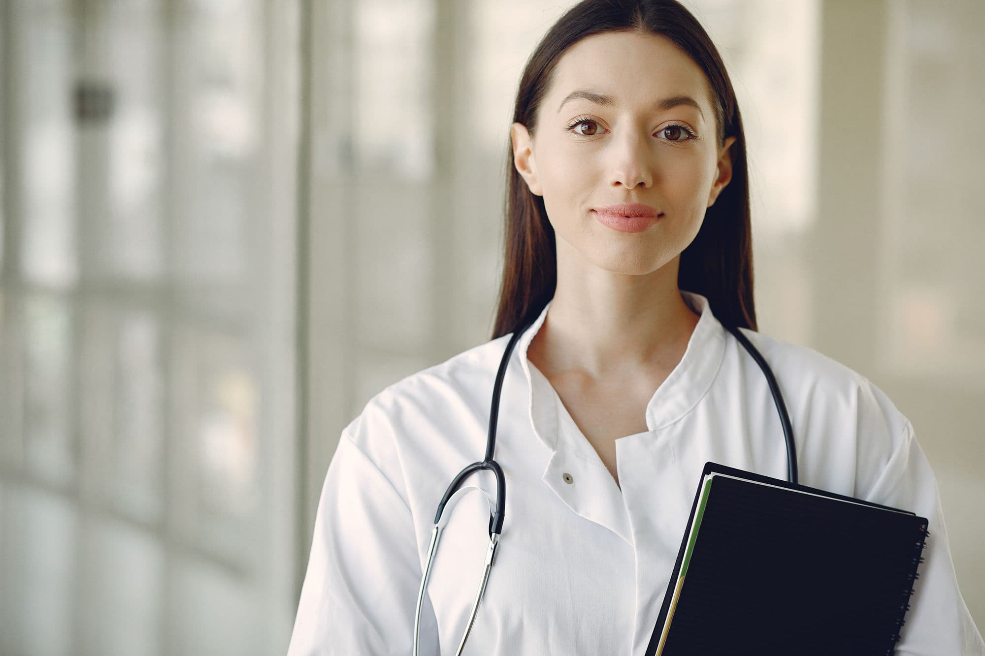Grace Lin in a white coat holding a clipboard