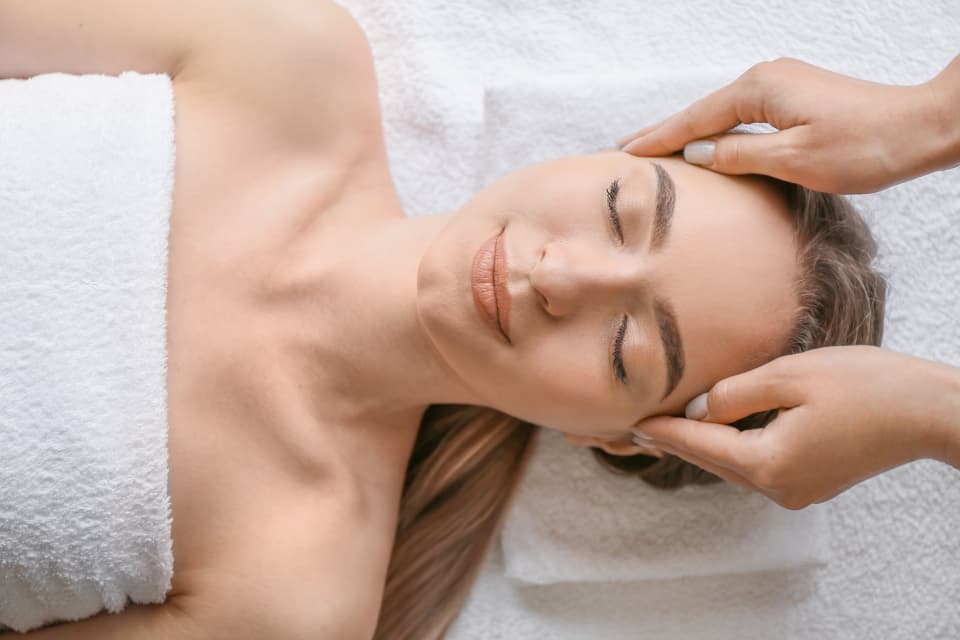 Esthetician giving a client a relaxing facial massage